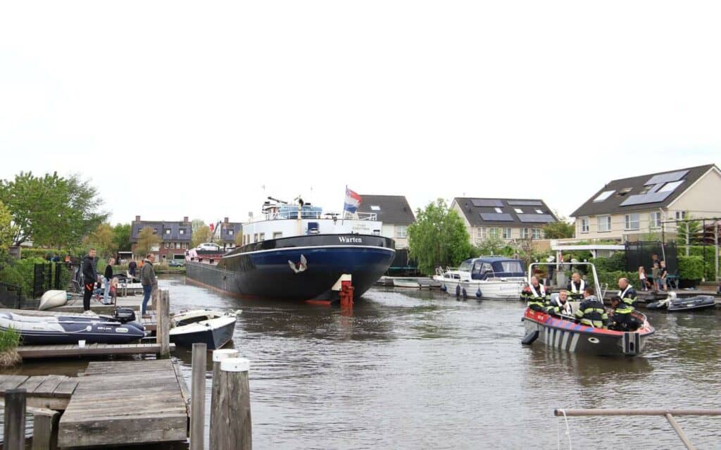 Schipper onwel: vrachtschip vaart woonwijk in Leeuwarden in en richt vernielingen aan